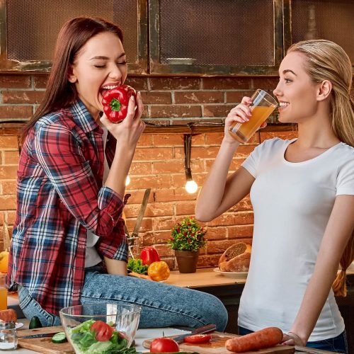 eat-well-to-be-well-young-female-friends-preparing-together-healthy-meal-in-modern-kitchen-cozy-1.jpg