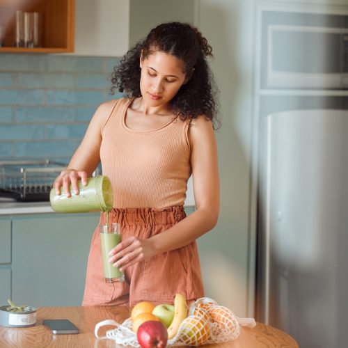healthy-nutrition-and-wellness-lifestyle-young-woman-making-fresh-green-detox-fruit-smoothie-for.jpg